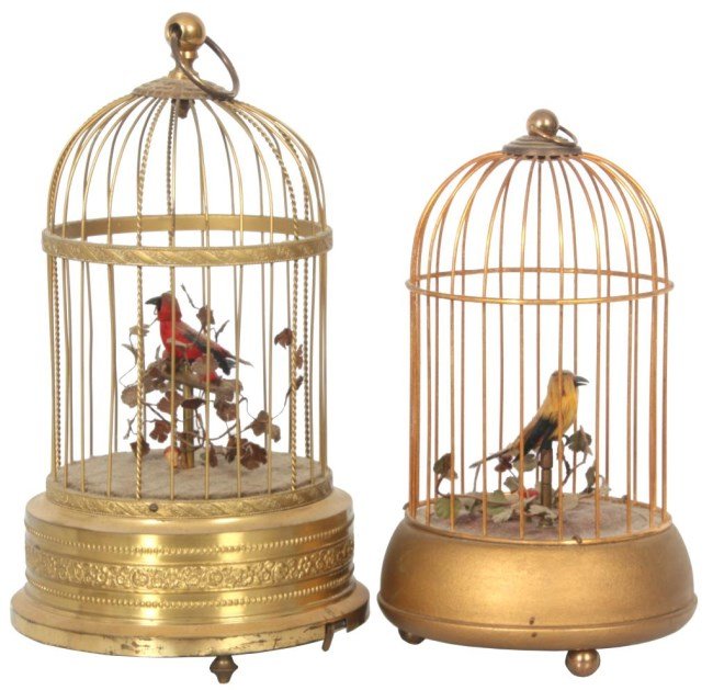 2 Brass Singing Bird Cage Automatons: 2 Brass Singing Bird Cage Automatons. One signed Karl Griesbaum, Germany, has a domical cage top and round base with a border of swirling filigree; spring driven mechanism drives the red feathered bir