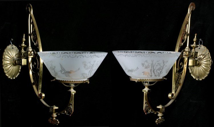 Pr. Brass Aesthetic Sconces: Pr. Brass Aesthetic Movement Sconces. Oval back-plate with hinged joint having a finial at the top; the long curved brass arm has a pierced decoration and valve switch at the bottom of the arch. Polis