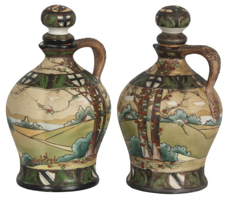 Pr. Nippon “Dark Woodland” Wine Jugs: Pr. Nippon “Dark Woodland” Wine Jugs. Scenic decorated with trees and brush in a country landscape with lion and shield borders, single handle, pinched spout and highlighted with black enamel outl