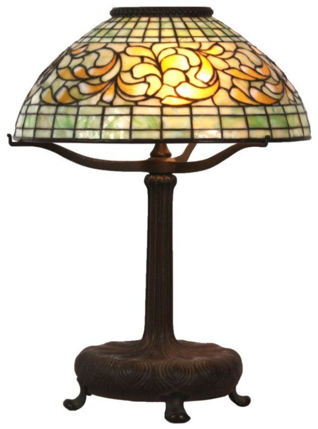 Tiffany Studios Swirling Leaf Border Table Lamp: 16 in. Tiffany Studios Swirling Leaf Border Table Lamp. The leaded shade has a domical form with a graduated 5 row geometric design at the top and 3 row geometric design at the lower rim in striated g
