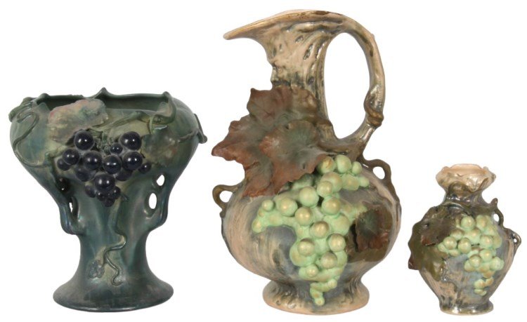 3 Pc. Austrian Grape Vases & Ewer: 3 Pc. Austrian Grapes. Amphora vase has a blue-green glaze with slight iridescence, 3 pierced handles under the bowl form top section and decorated with a hanging grape cluster and surrounding vines a
