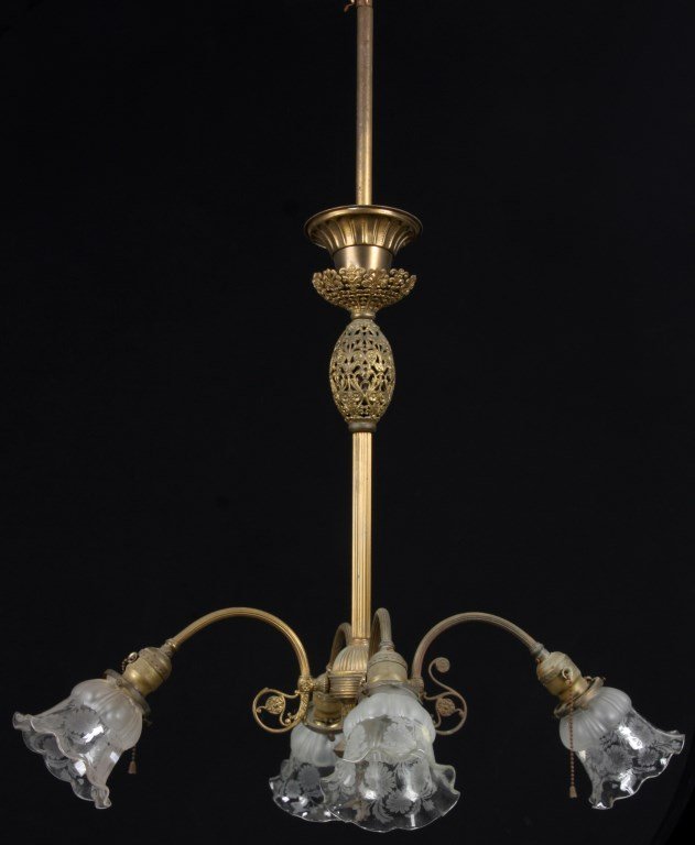 Brass 4 Arm Chandelier: Brass 4 Arm Chandelier. Has a pierced brass collar and lemon shaped cluster in the mid-section of the stem with a reeded spherical cluster and teardrop finial; 4 arms branching out with downward point