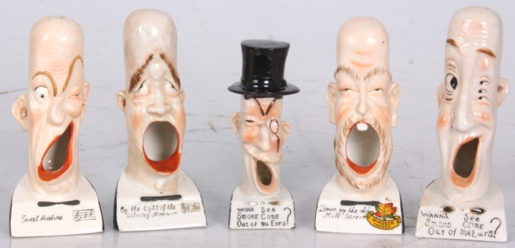 5 Shafer & Vater German Caracature Ashtrays: 5 Shafer & Vater German Figural Caracature Ashtrays. Porcelain figural man's heads have long faces with open mouths for holding cigarettes, hollow bodies hold the ash and pierced ear holes allow smoke