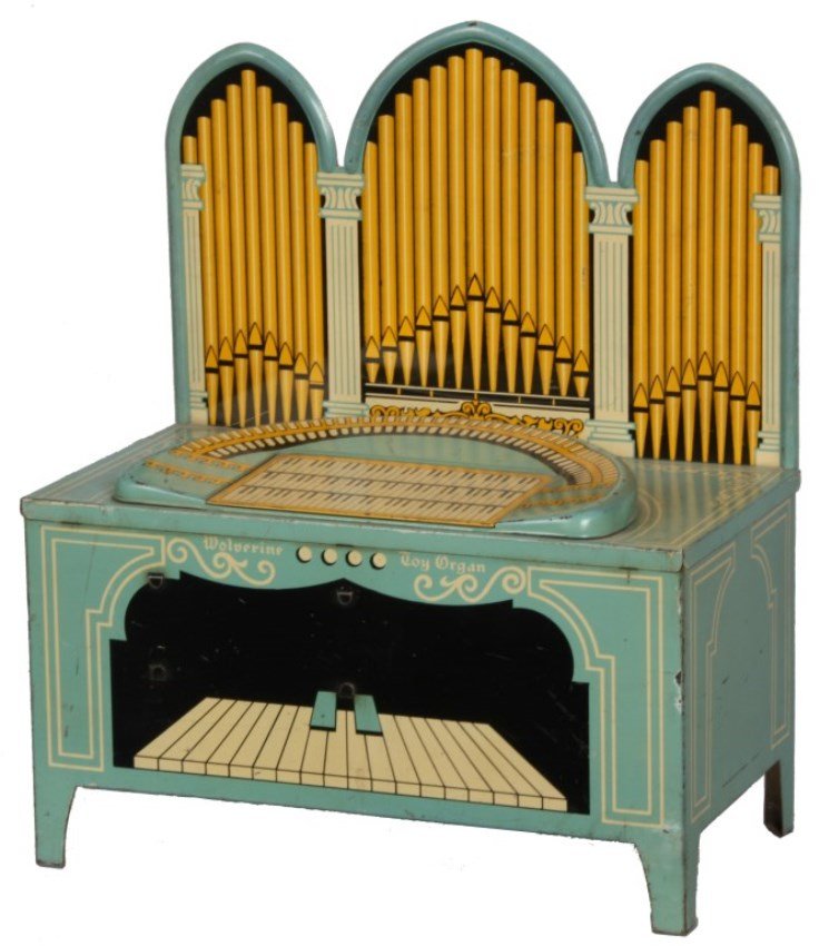 Wolverine Litho Tin Toy Organ: Wolverine Litho Tin Toy Organ. Pale blue decorated with organ keys, petals and gothic triple arched back panel with pipes; crank in the rear operates the internal organ “pipes”. In good physical c