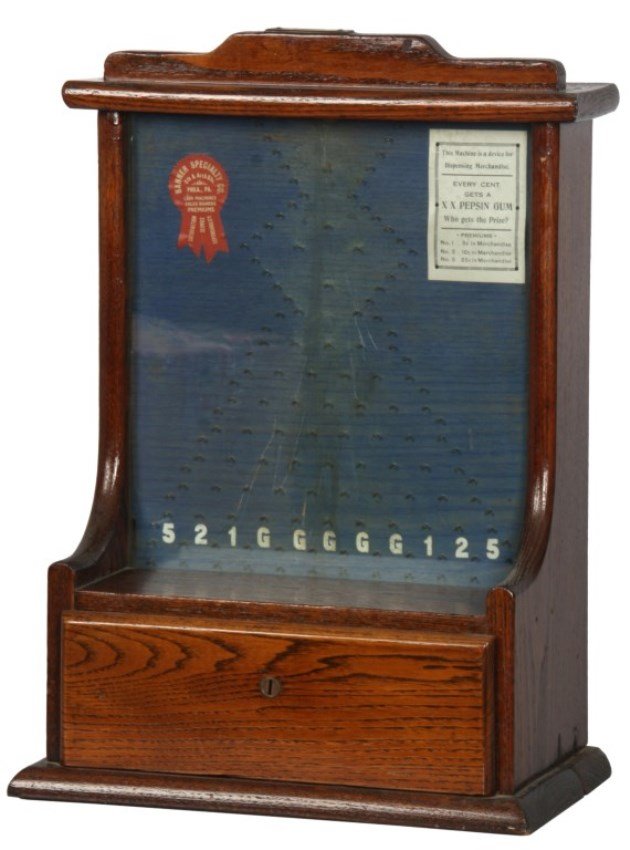 Early Penny Arcade Drop Machine: Early Penny Arcade Drop Machine Trade Stimulator. Oak wood case has a brass coin slot in the top; drop the penny onto the vertical game board with pins directing the penny to various end slots in the