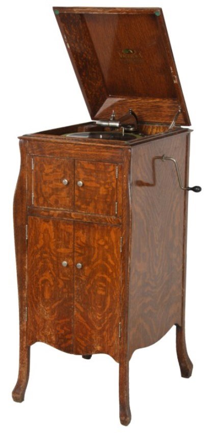 Oak Victor Model VV-X-A Victrola: Oak Victor Model VV-X-A Victrola. Beautiful oak case has a hinged lid with serpentine corners over carved feet, double door music storage compartment and double doors enclosing the horn; the interior 