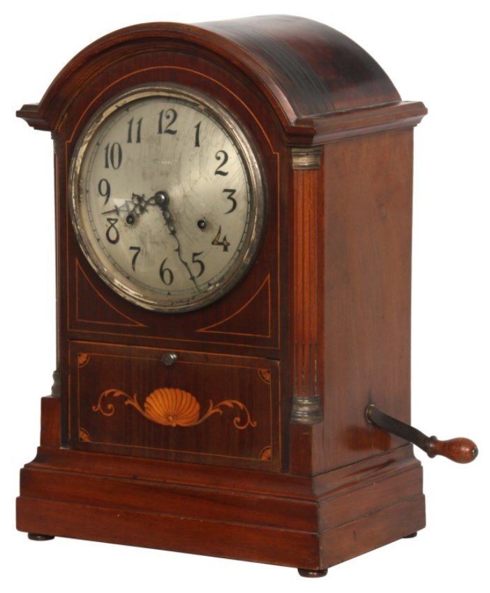 Sonora Chime Mahogany Bracket Clock: Sonora Chime Mahogany Bracket Clock. Mahogany case has an arched top, inlaid borders, turned and fluted corner columns with brass capitols and lower panel with seashell inlay and quarter fan inlays in