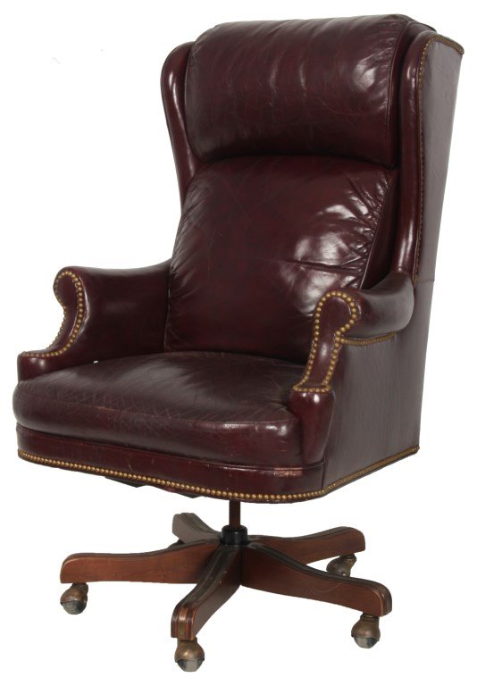 Leathercraft High Back Tilt Swivel Executive Chair: Leathercraft High Back Tilt Swivel Executive Chair. Red leather chair with brass tacks on the wing back, arm fronts and under the seat; has 4 walnut legs with the seat swiveling on a threaded post and