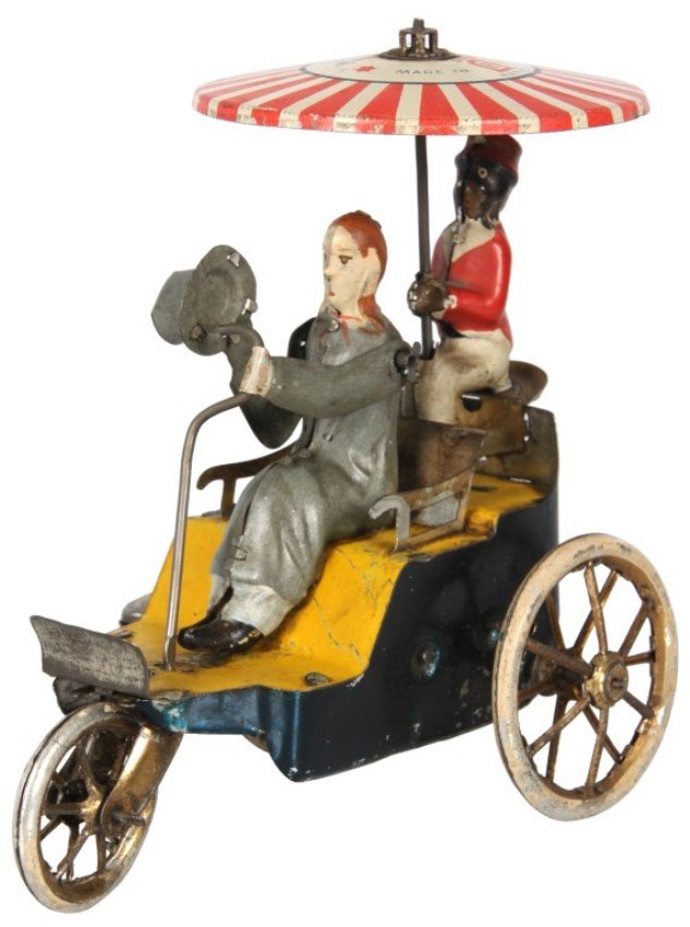 Lehmann “Ampol” Tin Windup Toy: Lehmann “Ampol” Tin Windup Toy. 3 wheeled vehicle with gentleman steering and butler in the rear holding an umbrella; when wound the buggy moves forward, the man moves his hat up and down in his r