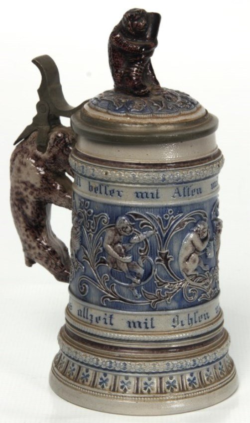 Salt Glaze Musical Stein: Salt Glaze Musical Stein. Gray salt glaze stein with blue highlights, has a filigree relief scene of cats & drinking monkeys, a monkey holding a drinking vessel finial and a figural bear handle with p