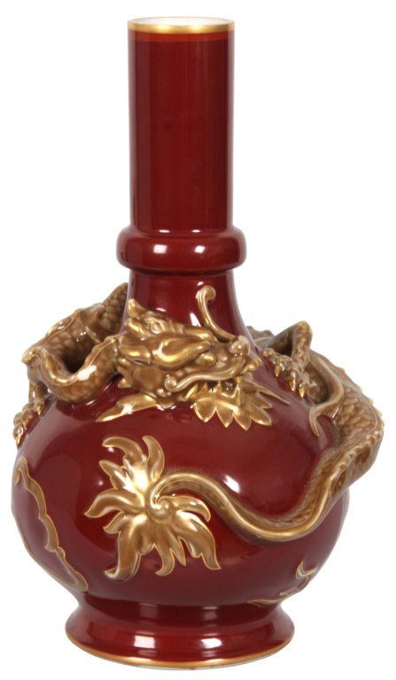 Porcelain Oxblood Dragon Vase: Porcelain Oxblood Dragon Vase. The large vase has a bulbous body with a long bottle neck which is lobed just above the shoulder, the vase is wrapped with a scaled dragon figure having an olive green g