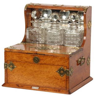 Oak Tantalus Game Box: Oak Tantalus Game Box. Oak case with brass mounts, hinges and handles, has a high mirrored back with 3 cut glass decanters with stoppers, double hinged lid with storage for 3 decks of cards, cribbage