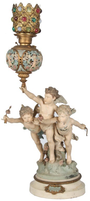 Figural Painted Banquet Lamp – Loves Victory: Figural Painted Banquet Lamp – Loves Victory. 3 winged putti figures, one holds a bow and a heart, one holds an arrow and is reaching for the heart and the center figure holds up the lamp which has 