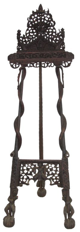 Figural Pierced Carved Burmese Easel: Figural Pierced Carved Burmese Easel. Fancy filigree pierced carved crest with figural phoenixes and Buddhist figural finials; has 2 long splayed legs wrapped with serpent-like tails, the heads (missi