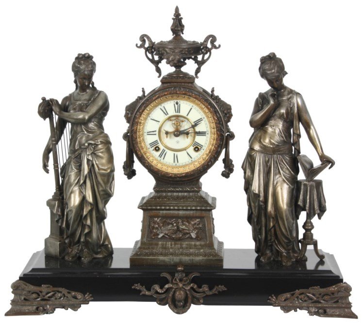Ansonia Double Figural Mantle Clock: Ansonia Double Figural Mantle Clock titled “Music & Poetry”. Standing white metal classical figural woman wearing long robes, one to the left playing a harp, the figure to the right reads from a b