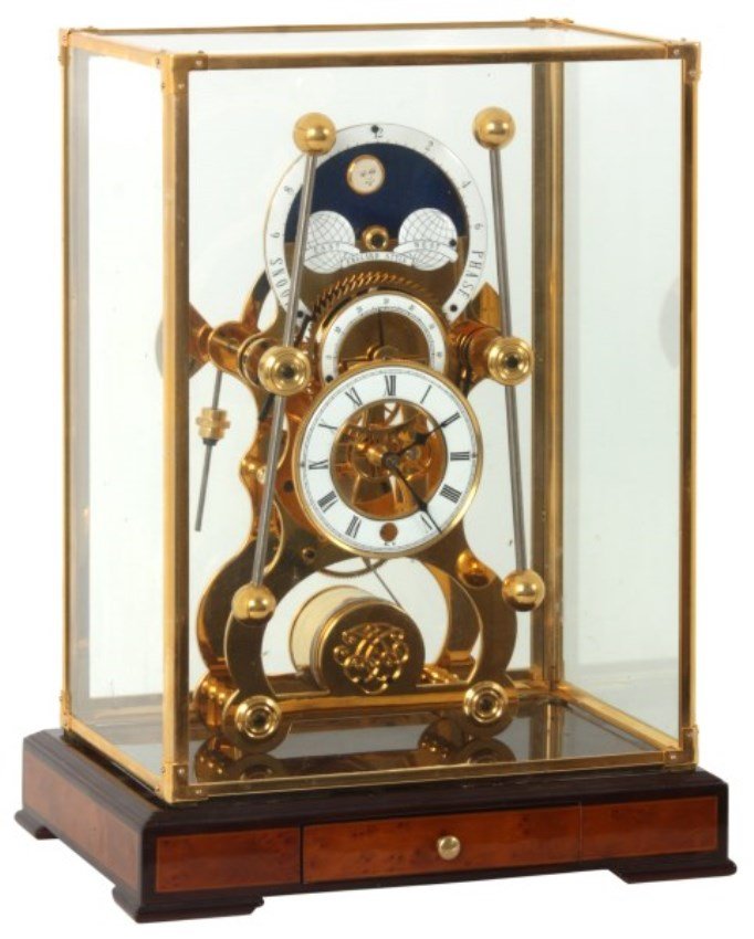 Harrison Grasshopper Skeleton Clock (Replica): Harrison Grasshopper Skeleton Clock (ProClocks Replica, made in China). Has a highly polished quality grained walnut & maple platform base with single drawer holding the key, square glass dome with go