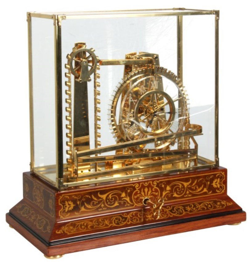 Animated Water Wheel Skeleton Clock (Replica): Animated Water Wheel Skeleton Clock (ProClocks Replica, made in China). This clock has a 6.5 in. glass dial, Graham deadbeat escapement with movement driven by the steel balls in the right hand side o