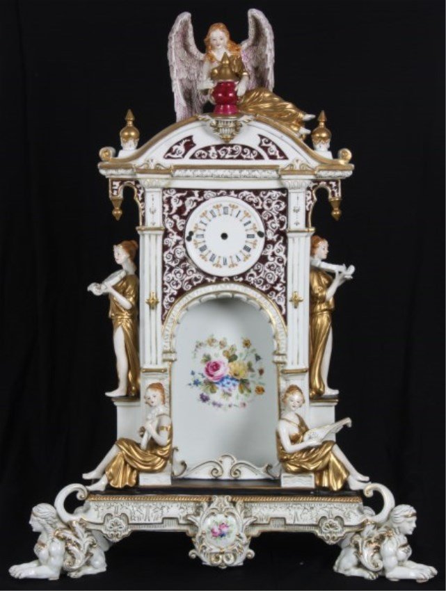 Attr: Meissen Figural Porcelain Clock Case: Attr: Meissen Figural Porcelain Clock Case. Elaborate clock tower with arched center, figural winged angel on top holding and urn, standing maidens playing violins on either side, seated maidens in th