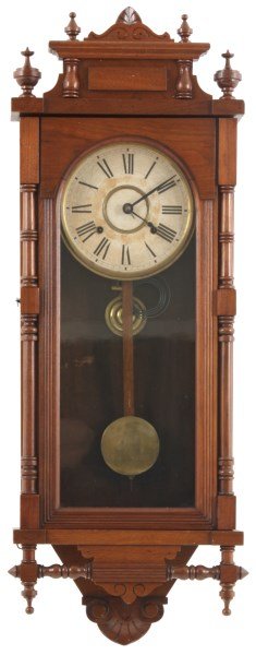 Ansonia Walnut Wall Regulator – Queen Elizabeth: Ansonia Walnut Wall Regulator – Queen Elizabeth. 8 in. paper dial with Roman hour numerals; brass 8 day spring driven movement signed “Ansonia Clock Co.” has and half hour strike on a coiled gon
