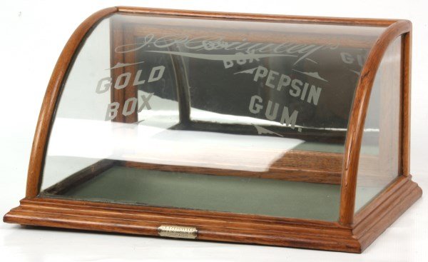 Curved Pepsin Gum Counter Top Display Case: Curved Pepsin Gum Counter Top Display Case. Oak case with curved & etched front glass reading “Pepsin Gum – Gold Box”. Signature tag on the front reads “J. Riswig, Chicago”. 9.5 in. high x 1