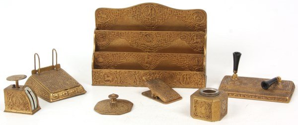 7Pc. Tiffany Studios Zodiac Desk Set: 7Pc. Tiffany Studios Zodiac Desk Set. Gold dore bronze desk set decorated in Tiffany’s Zodiac pattern, includes No. 1055 inkwell w/ glass insert, No. 274 postal scale, No. 1080 paper clip, No. 1093 