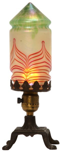 Attr: Loetz Artglass Lamp: Attr: Loetz Artglass Lamp. Cylindrical lobed shade with conical dome, iridescent opaque glass with green oil spot point and red pulled & threaded pattern; unsigned, has very minor fitter chips, 7 in.