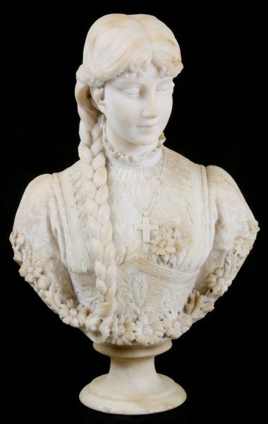 Carved Alabaster Bust Of A Woman: Carved Alabaster Bust Of A Woman. The young woman wears a lacy blouse with corset waist and ruffled collar with a cross around her neck, has long braided hair hanging in front of her right shoulder an