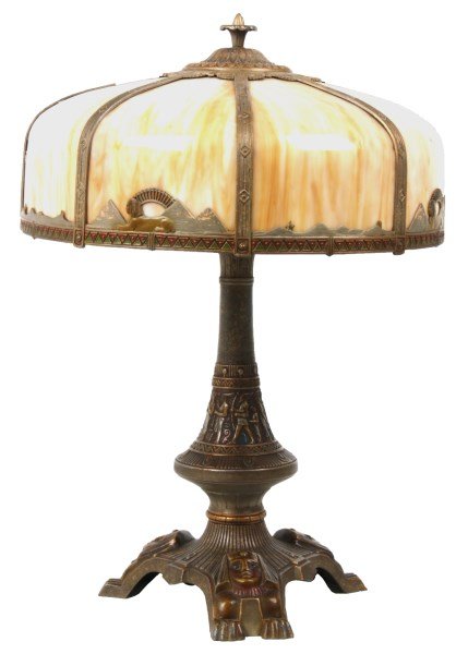 Attr: Parker Egyptian Revival Table Lamp: Attr: Parker Egyptian Revival Table Lamp. 18 in. dia. 8 panel bent slag glass shade with overlaid straps and lower border with Egyptian sphinx & pyramids; the 3 legged base has pharaohs heads over sph