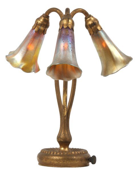Tiffany Studios 3 Light Lily Lamp: Tiffany Studios 3 Light Lily Lamp. The gold dore bronze base has a reeded platform which is concave in the center, above a cluster branches up with 3 floral stems with a serpentine form, tied in a bun