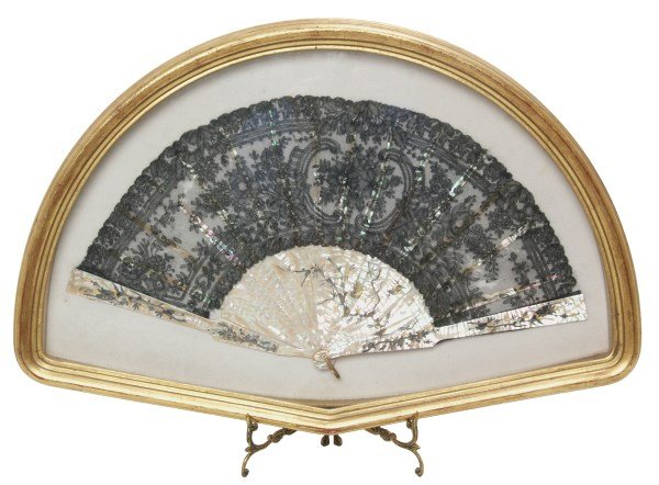 Mother of Pearl Fan in Shadow Box Frame: Mother of Pearl Fan in Shadow Box Frame. 16 Etched and pierced carved mother of pearl veins with filigree branches, birds and gilt highlights, brass hanger and black lace. Has some loss to the lace, m