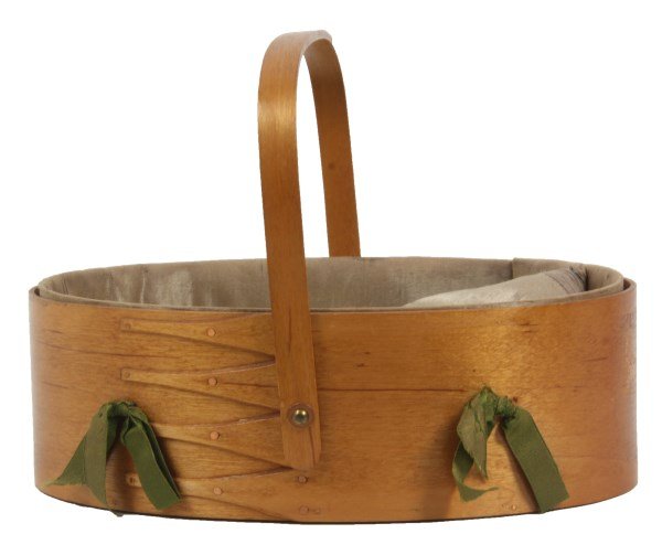 Shaker Oval Bentwood Sewing Box: Shaker Oval Bentwood Sewing Box. Beautiful box with hinged handle, lapped 4 finger construction with tacks, has a lined interior with ribbons tying sewing accessories to the interior. In nice conditio