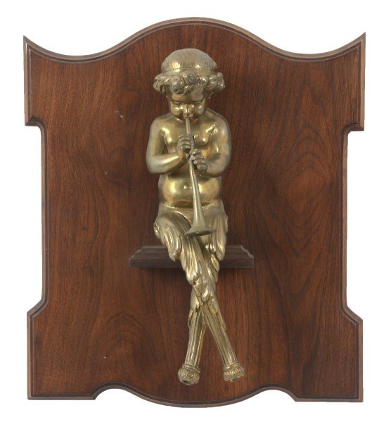 Gilt Bronze Figural Cherub: Gilt Bronze Figural Cherub. 13 in. gilt bronze figure of a seated cherub playing a horn; figural mount from a chandelier by Henry Dasson, c.1875, in good condition and mounted on a walnut wall mounted
