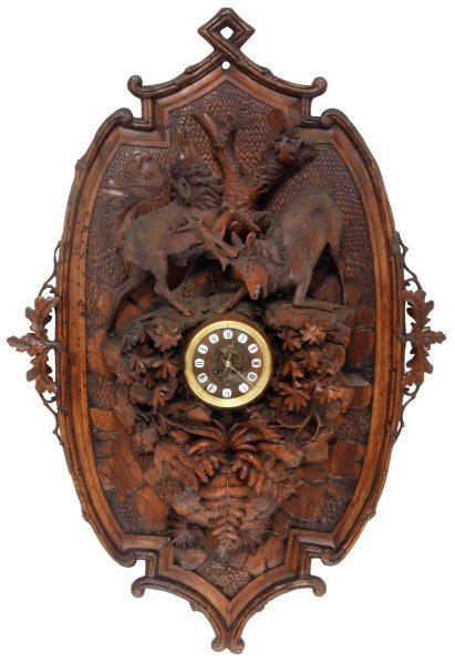 Large Black Forest Carved Wall Clock: Large 44 in. Black Forest Carved Wall Clock. 5.5 in. carved wood dial with applied porcelain Roman hour numerals, gilt hands, brass bezel with convex beveled glass; typical brass 8 day spring driven m