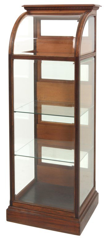Walnut Curved Front Display Cabinet: Walnut Curved Front Display Cabinet. Tall, narrow cabinet with beveled glasses all around. The back has 4 spring hinged doors dropping down with beveled glass panels and brass pulls, the top has an ar