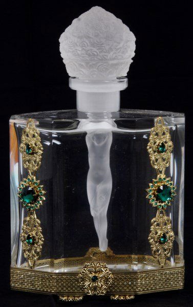 Attr: Hoffman Glass Perfume Bottle: Attr: Hoffman Glass Perfume Bottle. Excellent clear glass bottle has a lozenge form with pierce gilt brass mounts on the lower edge, feet and on the front with green jeweled highlights; the bottle has