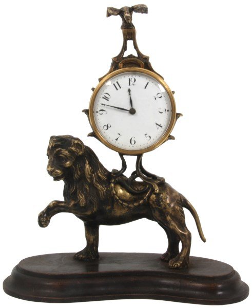 Figural Lion Desk Clock w/ Erotic Panel: Figural Lion Desk Clock. 2.5 in. porcelain dial with black hour numbers, black hands and brass bezel with beveled crystal; small round spring driven fuse watch-type movement signed “Cranbrook, Londo