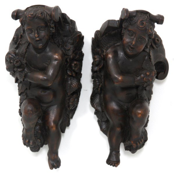 Pr. Figural Carved Putti Hanging Corbels: Pr. Figural Carved Putti Hanging Corbels. Opposite facing carved walnut figural nude putti surrounded by flowers. Excellent figures are adapted from a larger piece, they are in nice overall refinished