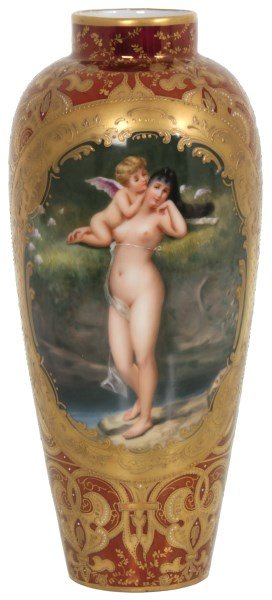 Royal Vienna Porcelain Vase: Royal Vienna Porcelain Vase. Ruby red vase decorated with gilt and enamel filigree and has an oval hand painted center panel with a nude figure of a woman attended by a winged putti, artist signed “