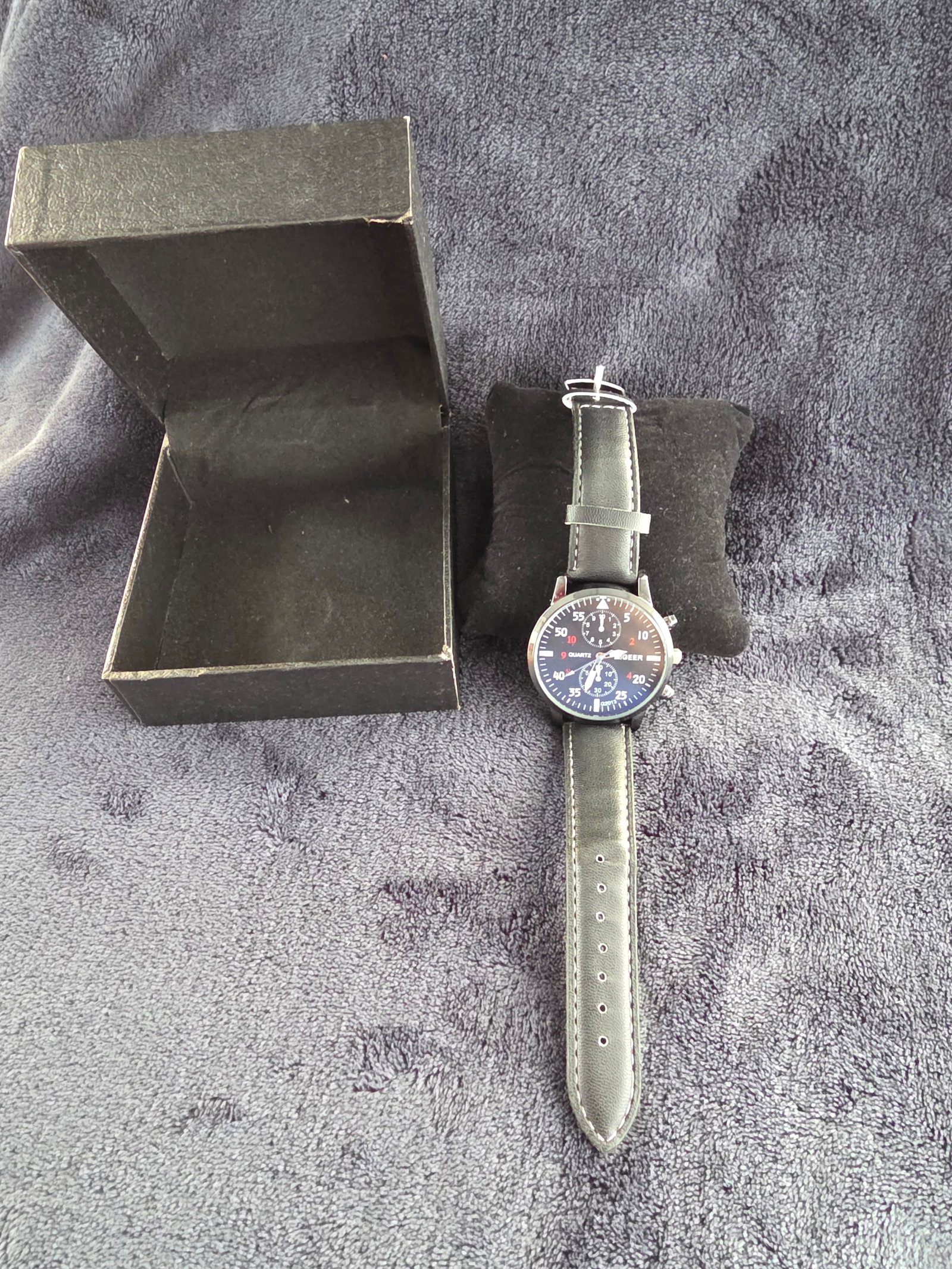 Jill's Coins and Collectibles- Vintage and Antique Jewelry: New in the box. this Mens Quartz MiGeer Analog Watch. Featuring a Black and White Face, and Black leather band, with White stitching. Produced by MiGeer in 2013 Made in the USA