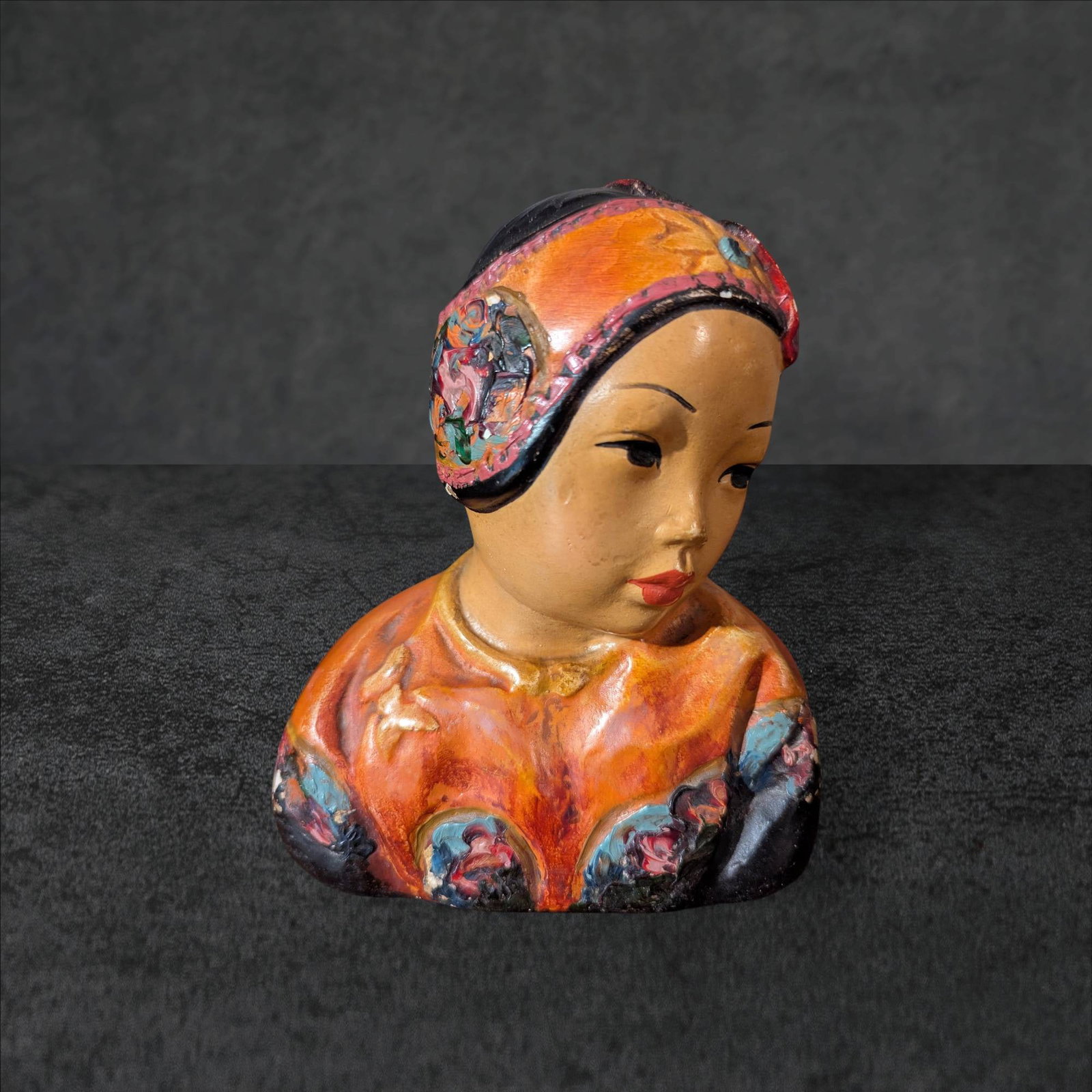 Esther Hunt Chalkware Asian Bust, â€˜Lotus Bud,â€™ Circa 1920s: A chalkware bust created by Esther Hunt, titled 'Lotus Bud,' from the 1920s. The sculpture represents an Asian figure with a detailed headdress and vibrant polychrome finish. Measuring approximately 6