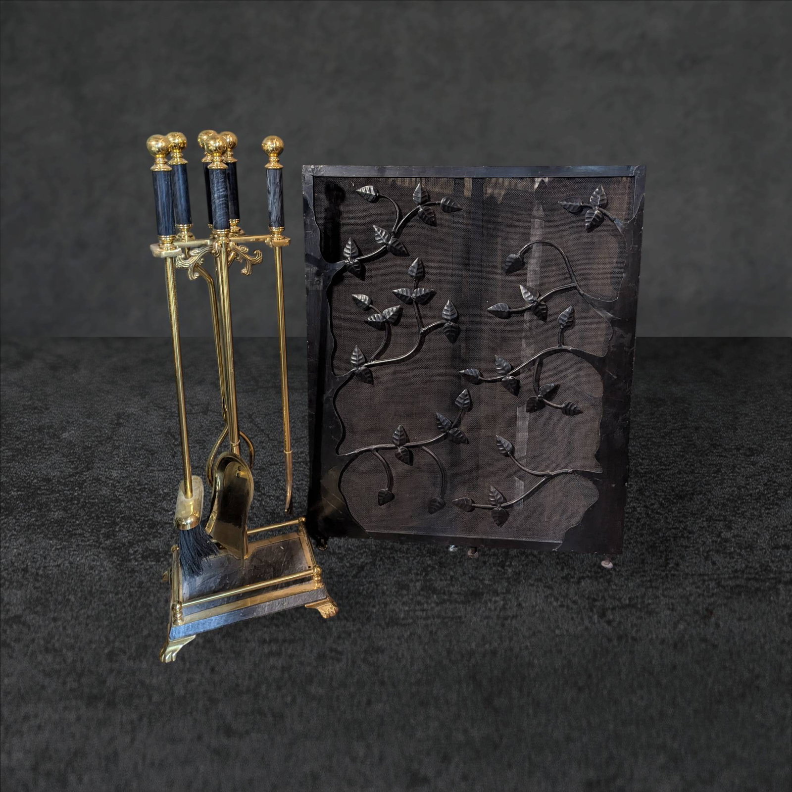 Fireplace Screen with Vine Design and Brass Tool Set with Marble Accents: Decorative fireplace screen measuring 48 inches wide by 29 inches high, featuring a black metal construction with an intricate vine design. Accompanied by a brass fireplace tool set measuring 33 inche