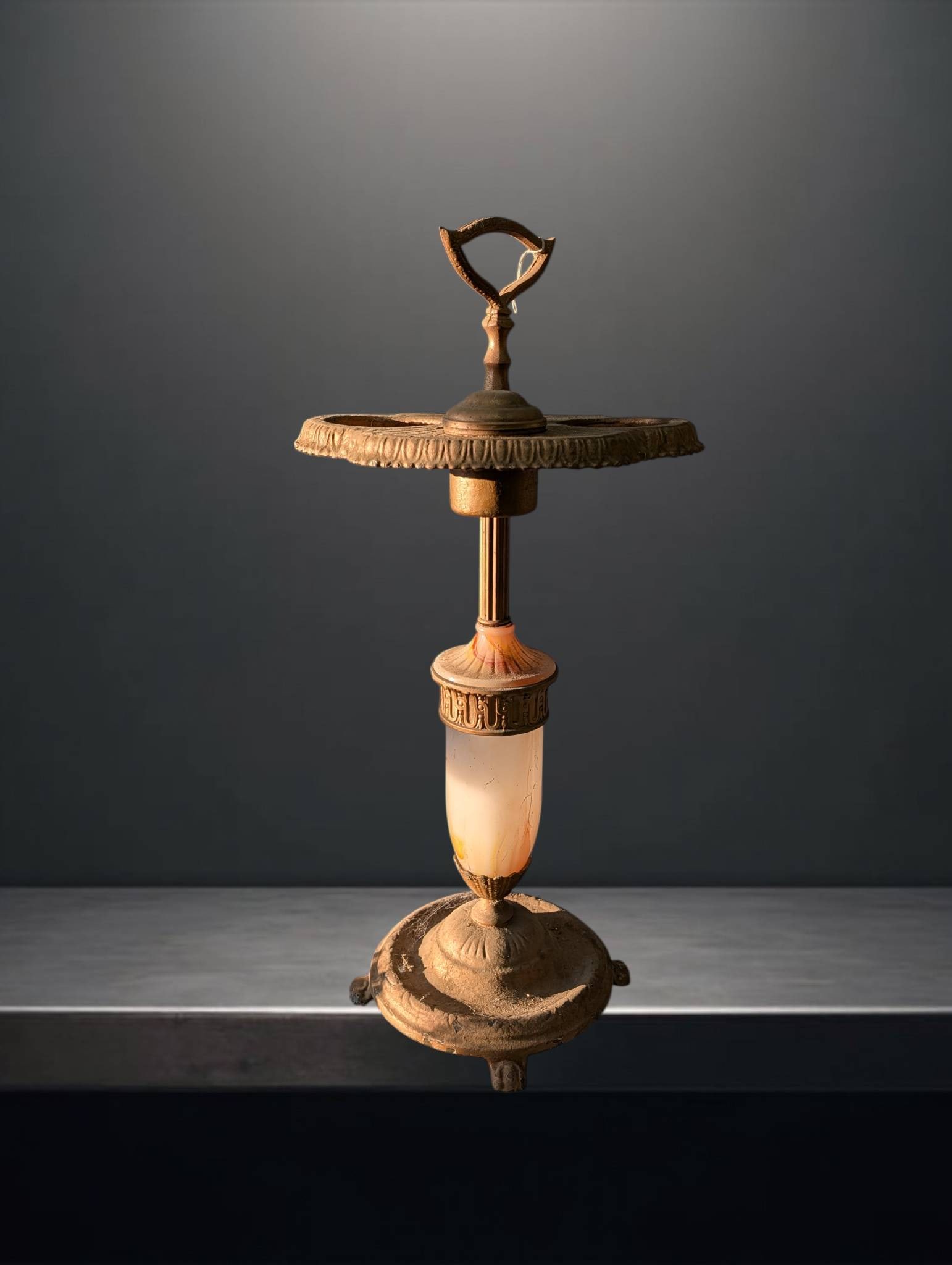 Art Deco Stand with Ornamental Design, 28 Inches Tall: Art Deco-style stand featuring intricate ornamental details. The piece includes a circular, multi-tiered top showcasing decorative edges, supported by a slender central column with a combination of me