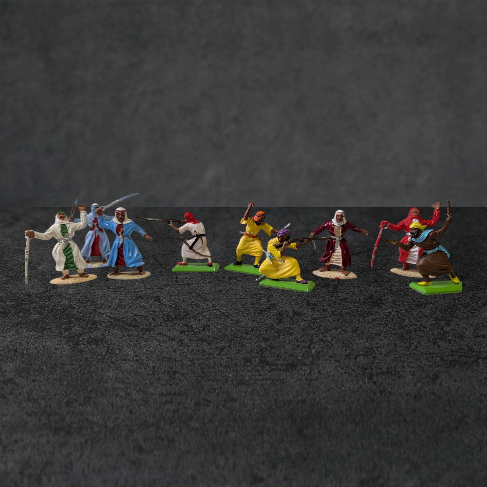 LTD. Deetail Plastic Arab Warrior Figures Made in England, 1970s: LTD. Deetail plastic figures depicting Arab warriors, made in England, dated to the 1970s. The set comprises eight hand-painted figures with distinctive stances and detailing, mounted on plastic bases