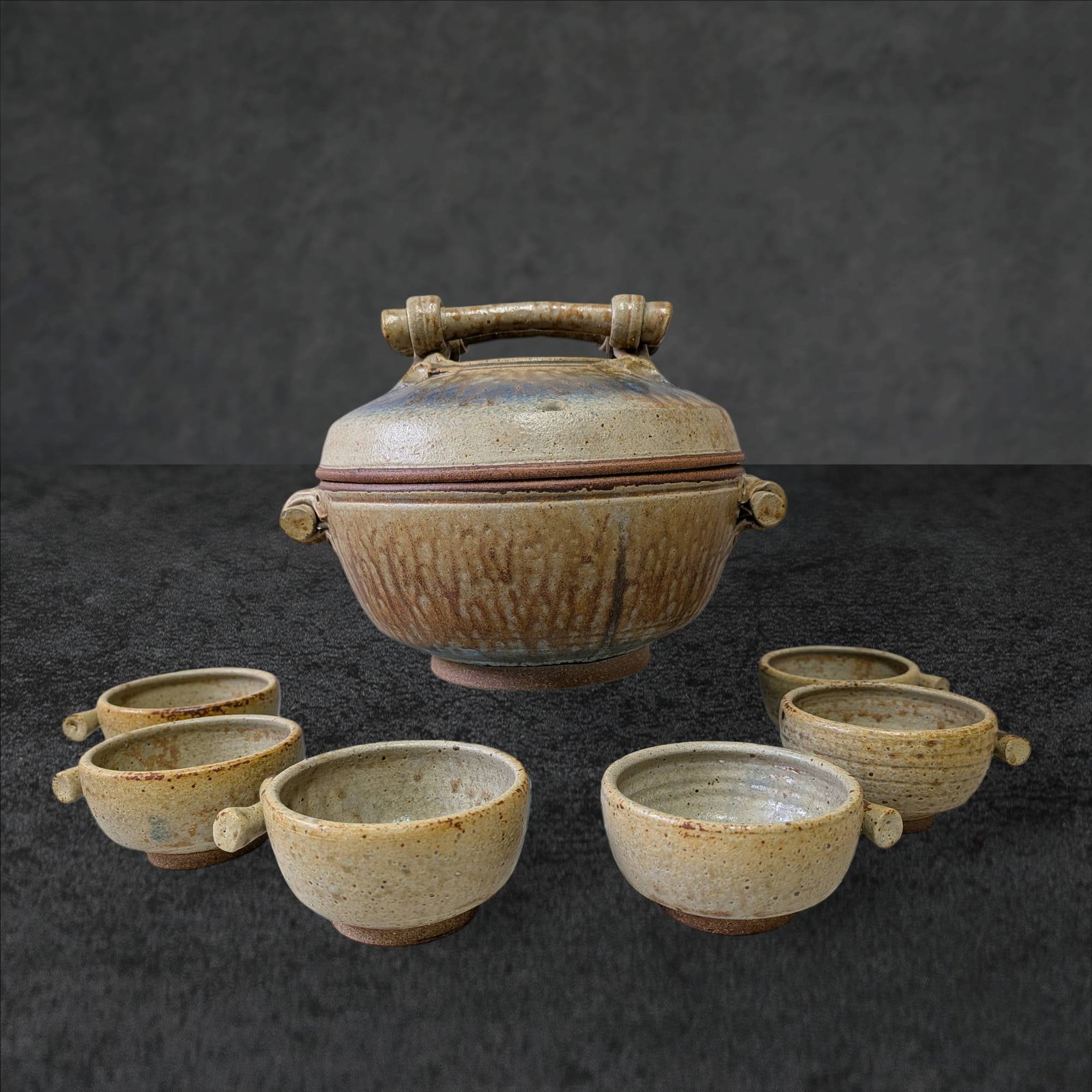 Asian-Inspired Ceramic Soup Tureen with Lid and Six Matching Bowls: Handcrafted ceramic soup tureen with a lid, measuring 13 inches in diameter and 10 inches tall. Accompanied by six matching bowls, each measuring 4.5 inches in diameter and 2.5 inches tall. The tureen