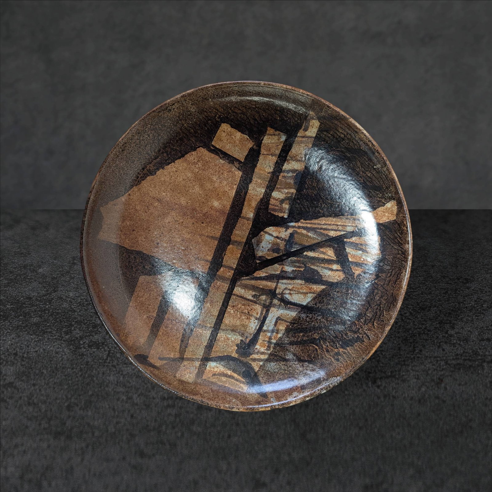 Large Asian-Inspired Ceramic Plate by Antony Pitot, 14-inch Diameter: Large ceramic plate influenced by Asian design, measuring 14 inches in diameter. Its painterly surface exhibits a style reminiscent of the Japanese Mingei (folk art) movement. The back displays a make