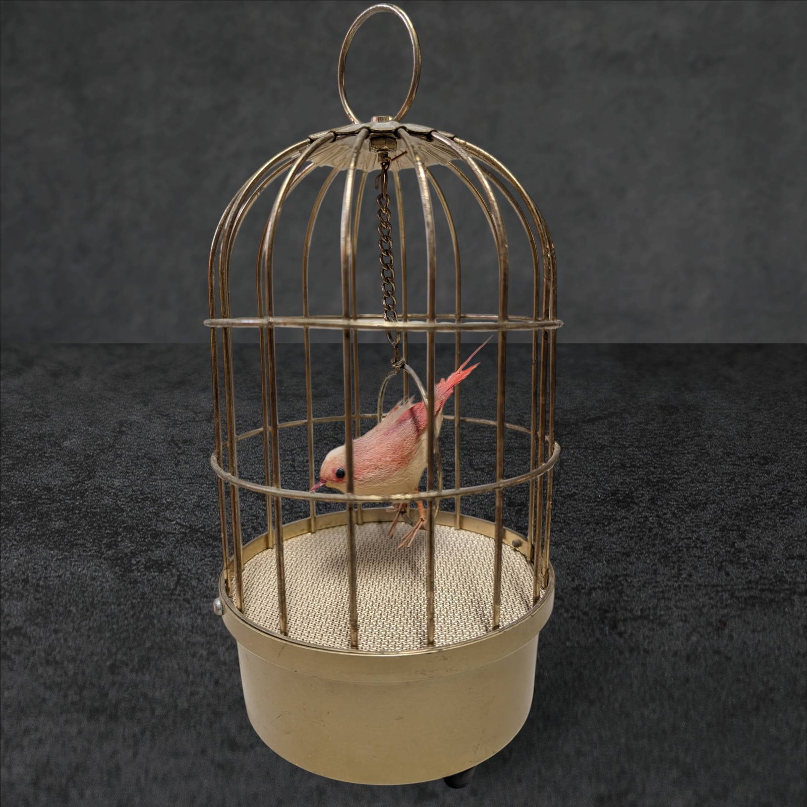 Mid-Century Saezuri Singing Bird in Birdcage, Made in Japan: Mid-century Saezuri singing bird in a birdcage featuring a musical mechanism powered by a transistored motor. The interactive bird moves and chirps when the mechanism is activated. Manufactured in Jap