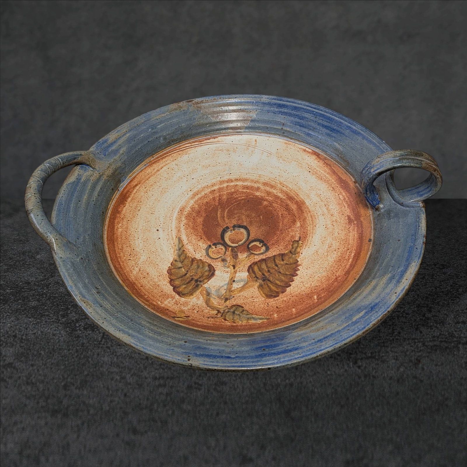 Large Signed Pottery Dish with Handles, Signed â€˜Bursleyâ€™: Handcrafted pottery dish featuring two looped handles and signed 'Bursley' on the underside. The dish measures 28 inches in diameter from handle to handle and 24 inches in the opposite direction. The 