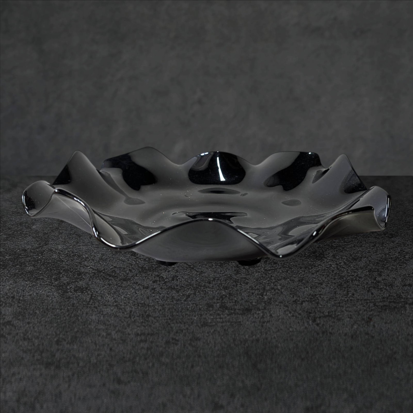 Black Amethyst Footed Bowl with Scalloped Rim, 13 in Diameter: Black amethyst glass bowl featuring a scalloped rim and footed base. Approximately 13 inches in diameter. The glass exhibits a dark, nearly opaque appearance with subtle amethyst undertones visible un
