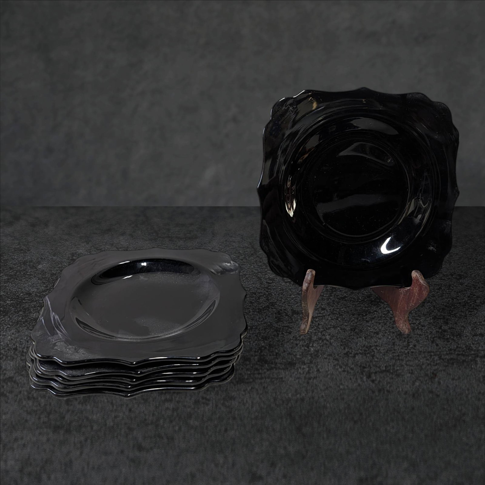 Six 7.5-Inch Amethyst Glass Salad Plates with Scalloped Edges: Six salad plates crafted from amethyst glass, measuring 7.5 inches in diameter. Each plate features a scalloped edge design and a glossy finish. The rich, dark amethyst hue showcases subtle transparen