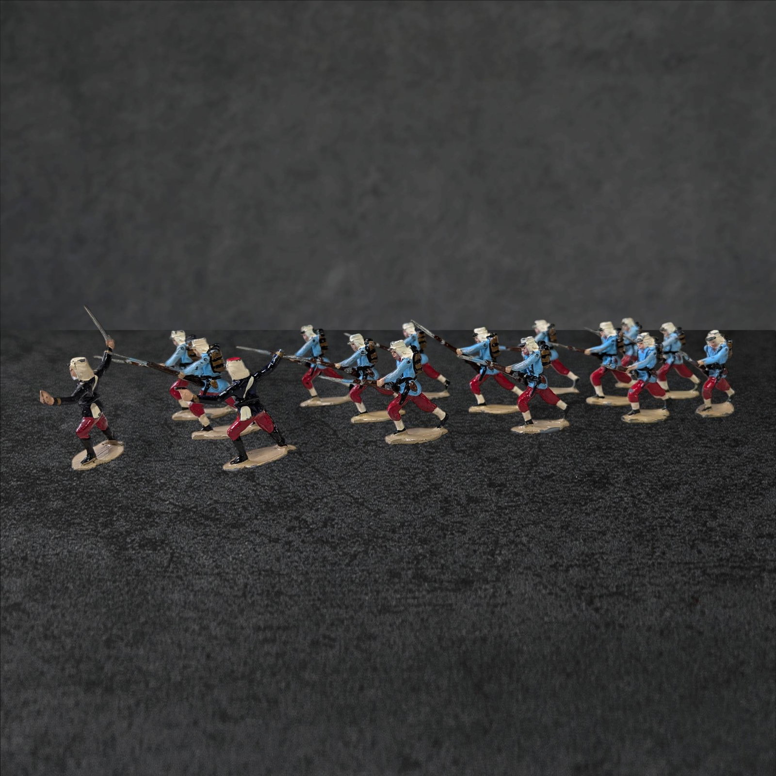 Articulating French World War I Soldiers, Approximately 2 Inches Tall: Articulating French World War I soldiers, each measuring approximately 2 inches in height. The figures are depicted in distinctive period uniforms with blue jackets, red trousers, and white kepis. The